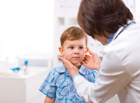 young child in examination room with doctor