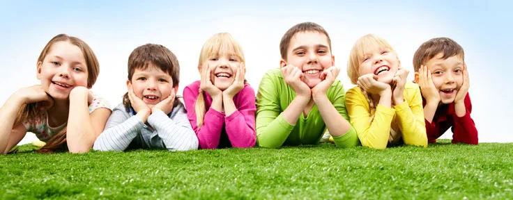 children laying in the grass