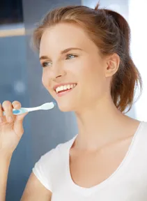 Teenage brushing her teeth