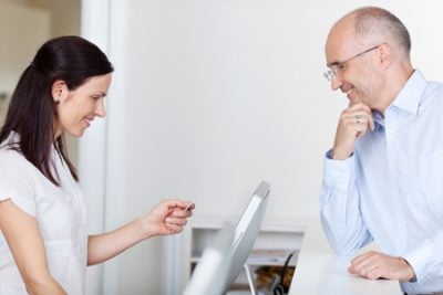 woman looking at insurance card